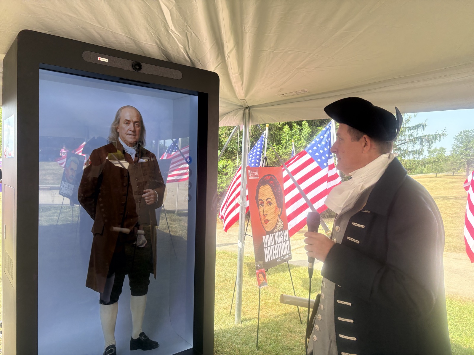 A guest speaks with the Ben Franklin hologram at the Hall of Giants